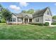 Beautiful home featuring a well-manicured lawn, covered front porch with columns, and attached garage, creating curb appeal at 8275 Normandy Rd, Denver, NC 28037