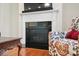 Close up on gas fireplace with decorative mantel and hardwood floors at 8275 Normandy Rd, Denver, NC 28037