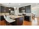 Eat-in kitchen with granite countertops, black cabinets, stainless steel appliances and hardwood floors at 8275 Normandy Rd, Denver, NC 28037