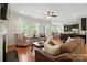 Open-concept living room with hardwood floors, fireplace, and views to the kitchen at 8275 Normandy Rd, Denver, NC 28037