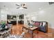 Spacious living room with hardwood flooring, stylish furniture, and access to dining area at 8275 Normandy Rd, Denver, NC 28037