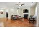Cozy living room featuring hardwood floors, a fireplace, and comfortable seating for relaxation and entertaining at 8275 Normandy Rd, Denver, NC 28037