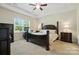 Spacious main bedroom with tray ceiling, large windows, and hardwood floors at 8275 Normandy Rd, Denver, NC 28037