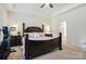 This main bedroom boasts a beautiful dark wood bed frame and trim with an ensuite bathroom at 8275 Normandy Rd, Denver, NC 28037