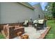 Inviting patio featuring comfortable seating, a brick fire pit, and well-maintained landscaping at 8275 Normandy Rd, Denver, NC 28037