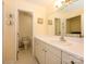 Well-lit bathroom with a large mirror, white cabinets, and tile flooring at 1047 Honeybee Trl, Fort Mill, SC 29715