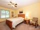 Bright bedroom with a large window, ceiling fan, and a comfortable rocking chair at 1047 Honeybee Trl, Fort Mill, SC 29715
