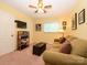 Comfortable bedroom with a sofa, television, and plenty of natural light at 1047 Honeybee Trl, Fort Mill, SC 29715