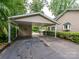 A home with a carport, showcasing the driveway and the surrounding landscaping with mature trees at 1047 Honeybee Trl, Fort Mill, SC 29715