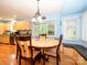 Bright dining area with built in seating, hardwood floors, and a view into the updated kitchen at 1047 Honeybee Trl, Fort Mill, SC 29715