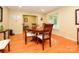 Inviting dining room features hardwood floors, natural light, and a round table with seating for four at 1047 Honeybee Trl, Fort Mill, SC 29715