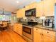 Updated kitchen showcasing stainless steel appliances, granite countertops, and light wood cabinetry at 1047 Honeybee Trl, Fort Mill, SC 29715