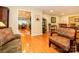 Spacious living room with hardwood floors flows into the dining room, offering an open and airy feel at 1047 Honeybee Trl, Fort Mill, SC 29715