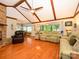 Bright living room with hardwood floors, brick fireplace, and vaulted ceilings with wood beams at 1047 Honeybee Trl, Fort Mill, SC 29715