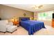 Comfortable main bedroom with ample lighting, a fan and ensuite bath at 1047 Honeybee Trl, Fort Mill, SC 29715