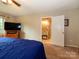 Spacious main bedroom with a large window, carpeted floors, and an ensuite bathroom at 1047 Honeybee Trl, Fort Mill, SC 29715
