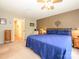 Cozy main bedroom featuring a large bed with blue comforter, ceiling fan, and calming neutral walls at 1047 Honeybee Trl, Fort Mill, SC 29715