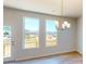 Open-concept dining area featuring hardwood floors, lots of light, and an exterior door to deck at 11017 Warfield Ave # 4, Huntersville, NC 28078