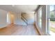 Open-concept living room featuring hardwood floors, a staircase, and an abundance of natural light at 11017 Warfield Ave # 4, Huntersville, NC 28078