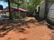 View of fenced backyard with trees and a building on the right side at 111/113 Shawnee Trl # D140/141, Mount Gilead, NC 27306