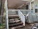 Exterior view of home featuring wooden steps leading to a cozy covered front porch at 111/113 Shawnee Trl # D140/141, Mount Gilead, NC 27306