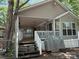 Exterior view of home featuring wooden steps leading to a cozy covered front porch at 111/113 Shawnee Trl # D140/141, Mount Gilead, NC 27306