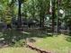 View of the front of the house with the yard, surrounded by a chain link fence at 111/113 Shawnee Trl # D140/141, Mount Gilead, NC 27306