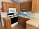 Kitchen boasts white appliances, laminate countertops, and wood cabinets at 111/113 Shawnee Trl # D140/141, Mount Gilead, NC 27306