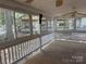 View of screened in porch with white railings and view of the neighborhood at 111/113 Shawnee Trl # D140/141, Mount Gilead, NC 27306