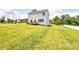 Expansive backyard featuring a well-maintained lawn, a small deck, and mature trees at 1542 Antioch Dr, Conover, NC 28613