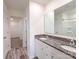 Modern bathroom featuring double vanity, granite countertop, and wood grain flooring at 1542 Antioch Dr, Conover, NC 28613
