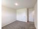 Cozy bedroom featuring new carpet, neutral walls, and a double door closet at 1542 Antioch Dr, Conover, NC 28613