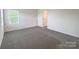 Clean bedroom featuring neutral walls, new carpet, and a window at 1542 Antioch Dr, Conover, NC 28613