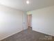 Spare bedroom featuring neutral carpet, neutral walls, and a window at 1542 Antioch Dr, Conover, NC 28613