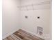 A bright laundry room featuring a wire shelf, vinyl floors, and modern hookups at 1542 Antioch Dr, Conover, NC 28613