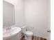 A half-bathroom featuring a pedestal sink and a toilet with hardwood-style flooring at 1542 Antioch Dr, Conover, NC 28613