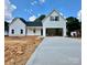 New construction home featuring white vertical siding and dark accents on the roof and window shutters at 1678 Sharon Ln # 12, Lancaster, SC 28720