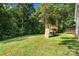 Lush backyard featuring a wooden playset, trampoline, and ample space for recreation at 1774 Timmons Marie Ln, Lincolnton, NC 28092