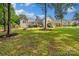 Large backyard featuring a deck with a slide, fire pit, and lush green lawn at 1774 Timmons Marie Ln, Lincolnton, NC 28092