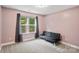 Bedroom featuring pink walls and a dark sofa at 1774 Timmons Marie Ln, Lincolnton, NC 28092