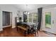 A dining area features natural light, modern black and wood furniture, and wood flooring at 1774 Timmons Marie Ln, Lincolnton, NC 28092