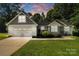 Stylish home showcasing a two-car garage, manicured lawn, and charming architectural details at 1774 Timmons Marie Ln, Lincolnton, NC 28092