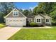 Charming single-Gathering home boasts a well-manicured lawn and an attached two-car garage at 1774 Timmons Marie Ln, Lincolnton, NC 28092