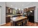 Stylish kitchen showcases dark wood cabinets, stainless steel appliances, and center island with seating at 1774 Timmons Marie Ln, Lincolnton, NC 28092