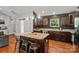 Well-appointed kitchen featuring an island, dark cabinets, granite countertops, and stainless steel appliances at 1774 Timmons Marie Ln, Lincolnton, NC 28092