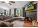 Cozy living room features a fireplace, TV, hardwood floors and comfortable furnishings at 1774 Timmons Marie Ln, Lincolnton, NC 28092