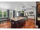 Open-concept living room features a kitchen island, wood floors, fireplace, and access to the outdoor deck at 1774 Timmons Marie Ln, Lincolnton, NC 28092