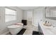 Bright bathroom featuring a soaking tub, vanity with dual sinks, and a walk-in closet at 1774 Timmons Marie Ln, Lincolnton, NC 28092