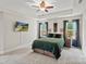 The main bedroom features a television, tray ceiling, and two bedside tables at 1774 Timmons Marie Ln, Lincolnton, NC 28092