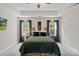 The main bedroom features a large bed, decorative wall art, and two bedside tables at 1774 Timmons Marie Ln, Lincolnton, NC 28092